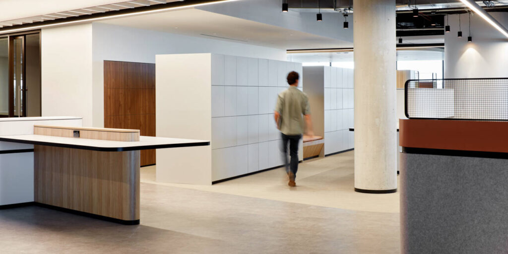 Man walking past sleek white laminate agile workplace lockers